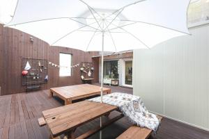 a dining room with a table and an umbrella at Haeundae HaeRium Hotel in Busan