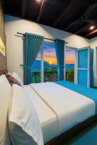 a bedroom with a large bed and a window at Munnar Tea Estate Cottage and Resort - Away From City Hustle in Munnar