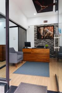 a living room with a tv on a brick wall at Munnar Tea Estate Cottage and Resort - Away From City Hustle in Munnar