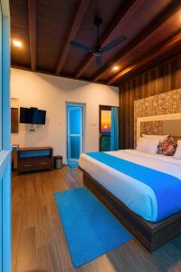 a bedroom with a large bed and a flat screen tv at Munnar Tea Estate Cottage and Resort - Away From City Hustle in Munnar +45 photos