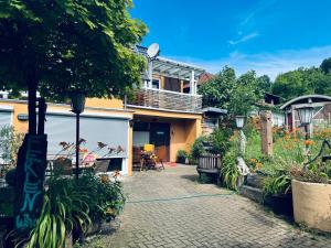 a house with a walkway in front of a yard at Apartment Villa Kunterbunt 2 EUROPAPARK RULANTICA STRAẞBOURG in Hohberg