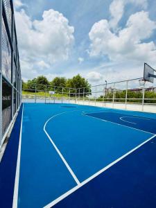 a blue tennis court with a net on it at UKM GMI Mirai Residence Kajang 2 in Kajang