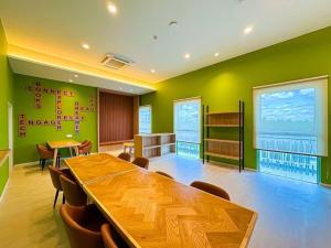 a conference room with a wooden table and chairs at UKM GMI Mirai Residence Kajang 2 in Kajang +30 photos