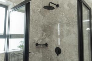 a shower in a bathroom with a glass door at Nine on Second in Gqeberha +53 photos