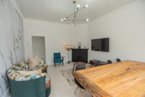 a living room with a table and a couch at Nine on Second in Gqeberha