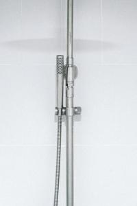 a shower with a shower head in a bathroom at SLEEEP HKG Causeway Bay in Hong Kong