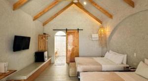a bedroom with two beds and a tv in a room at Santa Fe Beach Club in Ocoy
