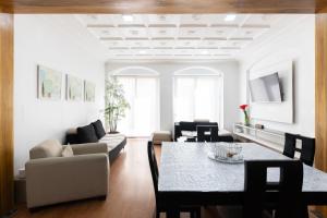 a living room with a table and a couch at Lumina Suites in Cuenca