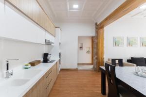 a kitchen and living room with a table and a couch at Lumina Suites in Cuenca +9 photos