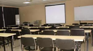 una classe con tavoli, sedie e schermo bianco di Jinjiang Inn JiNan Daminghu New Scenic Area Lishan Road a Jinan