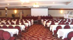 a conference room with tables and chairs and a screen at The Georgian Resort in Lake George +190 photos