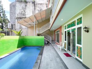 a swimming pool in the backyard of a house at The Lavana Kubu Be Long Sanur in Sanur