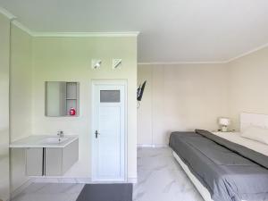 a bedroom with a bed and a sink at The Lavana Kubu Be Long Sanur in Sanur +11 photos