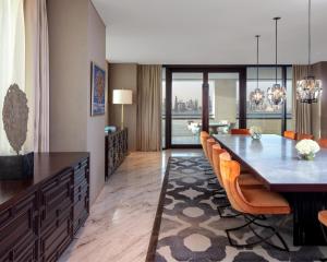 a dining room with a long table and orange chairs at Park Hyatt Doha, Msheireb Downtown in Doha +79 photos