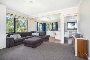 a living room with a couch and a table at Farmhouse on the Cradle Coast Forth in Forth