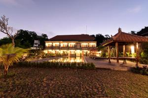 a large building with lights in front of it at Le Lima in Kuta