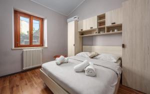 a bedroom with a bed with white pillows and a window at Villa San Rocco with heated pool in Vodnjan +48 photos