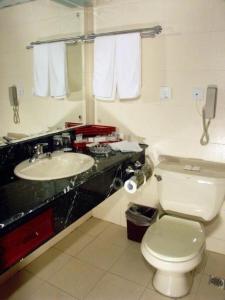 a bathroom with a white toilet and a sink at Heilongjiang Kunlun Hotel in Harbin