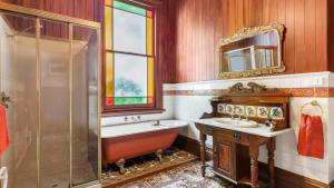 a bathroom with a tub and a sink and a shower at Mt Eden Victorian Villa in Auckland