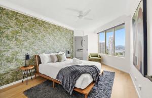 a bedroom with a bed with a green wall at Luxury 3BR Gold Coast Stay Ocean and City Views in Gold Coast