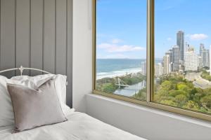 a bedroom with a bed and a large window at Luxury 3BR Gold Coast Stay Ocean and City Views in Gold Coast +17 photos