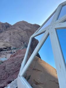 a window with a mountain in the background at Mannam desert dome in Dahab