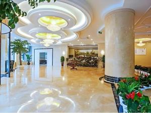 a lobby of a hotel with a large chandelier at GreenTree Inn HuZhou AnJi YingBin Avenue Express Hotel in Huangshu