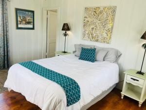 a bedroom with a bed with a blue and white blanket at Garden Cottage in Langley