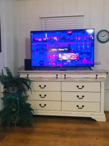a tv sitting on top of a dresser at Garden Cottage in Langley