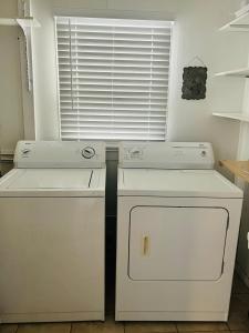 a kitchen with two white appliances and a window at Garden Cottage in Langley