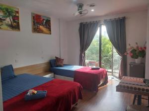 a hotel room with two beds and a balcony at Hanoi Train Street Hostel in Hanoi +17 photos