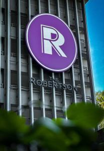 a building with a purple sign on top of it at The Robertson Bukit Bintang by Centurypro in Kuala Lumpur