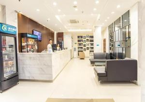 a man standing at a counter in a store at City Comfort Inn Nanning Dongge Yuanhu Road 1st Affiliated Traditional Chinese Medicin Hospital in Nanning