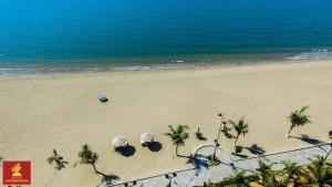 an aerial view of a beach with palm trees and the ocean at Gold Rooster Resort in Phan Rang