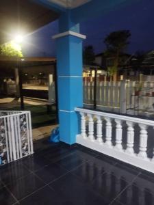 a blue column and a white railing on a building at Chegebu Homestay in Kampong Beringin +5 photos
