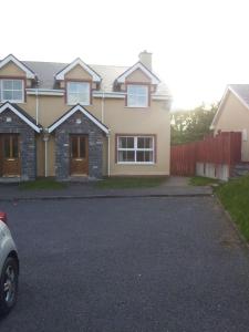 a house with a car parked in the driveway at 15 Sheen View Kenmare Co Kerry in Kenmare