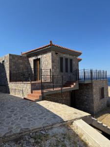 a small stone house with a balcony and a driveway at Endless View 2 in Mythimna