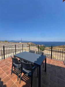 a table and chairs on a patio with the beach at Endless View 2 in Mythimna