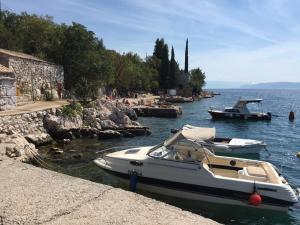 two boats are docked in a body of water at Apartment Keka in Dramalj