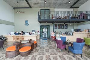 a restaurant with tables and chairs and a counter at The Sixteenth Naiyang Beach Hotel SHA Plus in Nai Yang Beach