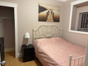 a bedroom with a bed and a picture on the wall at Vacation Home in Vancouver