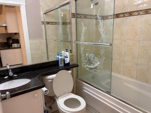 a bathroom with a shower and a toilet and a sink at Vacation Home in Vancouver