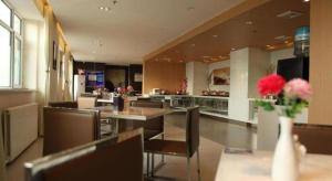 a dining room with tables and chairs and a restaurant at Jinjiang Inn Hohhot Dazhao Hospital Metro Station in Hohhot