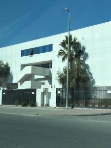 ein weißes Gebäude mit einem Zaun und einer Palme in der Unterkunft وحدة سكنية in Ta'if