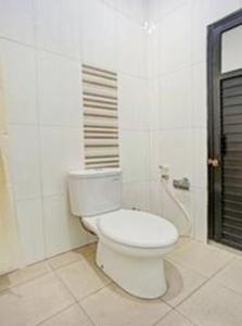 a bathroom with a white toilet in a room at Collection O 90693 ORCHID EDOTEL Boyolangu in Tulungagung +45 photos