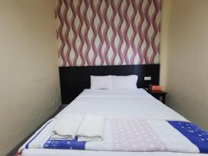 Postel nebo postele na pokoji v ubytování OYO 95059 Ikon Guesthouse