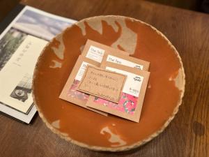 a plate with a card on top of it at The Bath and Bed Tateyama in Toyama