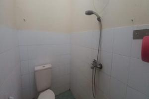 a shower in a bathroom with a toilet at OYO 95055 Homestay Panasan Pak Budi in Kedungtengkong
