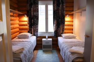 a small room with two beds and a window at Marttinen in Virrat
