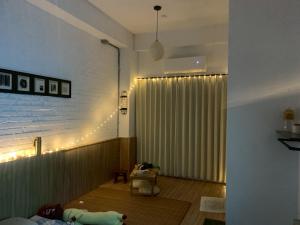 a living room with a large window with a curtain at 陌野輕旅民宿 in Xiulin